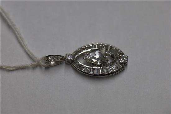 A platinum or white gold, pear, baguette and round cut diamond set elliptical shaped pendant,